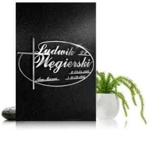 Granitowa tablica nagrobna z grawerowanym krzyżem i personalizowanym napisem.